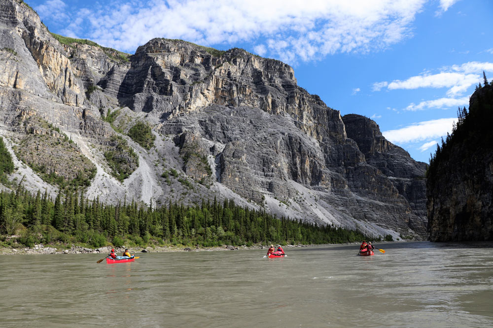 Canoeing through deep canyons on the Nahanni River
