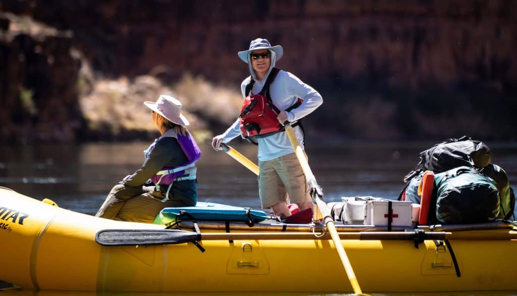 Two people rafting on a river.