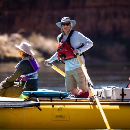 Two people rafting on a river.