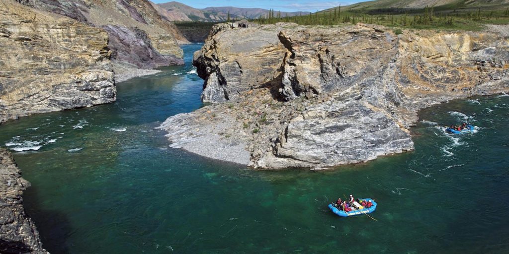 a group of people in a raft on a river