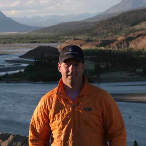 a man standing in front of a river