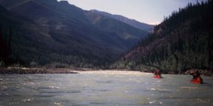 a group of people in a canoe on a river