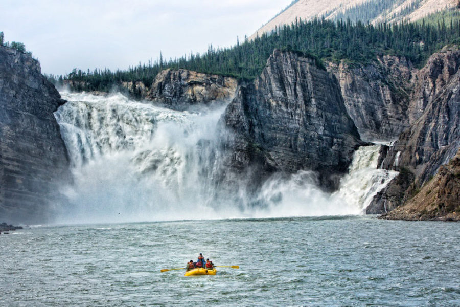 Rafters in front of Virginia Falls on the Nahanni River in Nahanni National Park and UNESCO World Heritage Site.