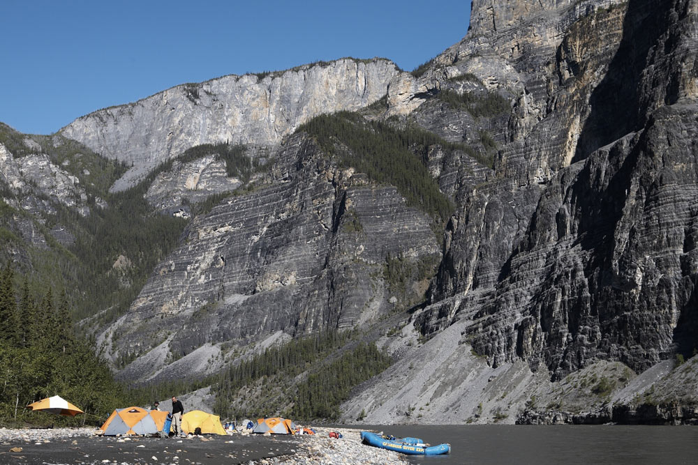 Camping on a sandy beach within the depths of first canyon on the Nahanni River in Nahanni National Park Preserve.