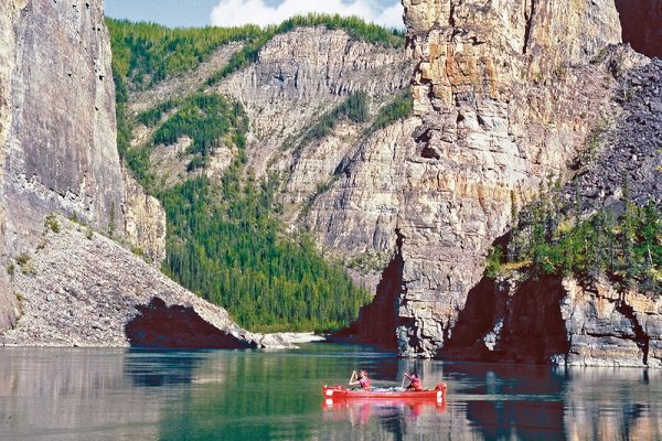 Canoeing through Canada's deepest river canyons on the Nahanni River in Nahanni National Park Preserve.