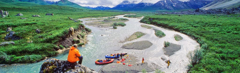a group of people standing on a river