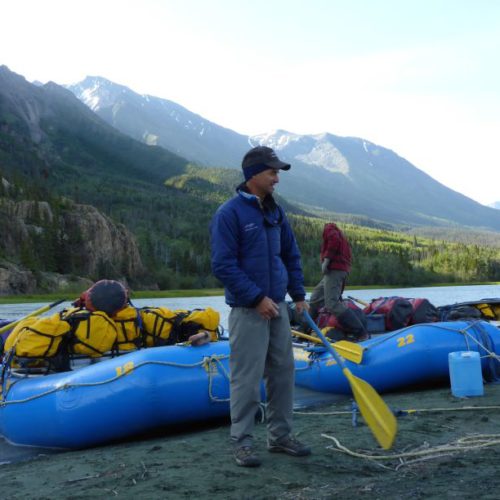 a man standing next to a raft