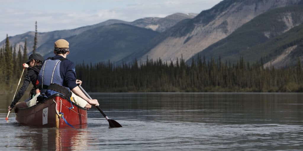 a person in a canoe on a lake
