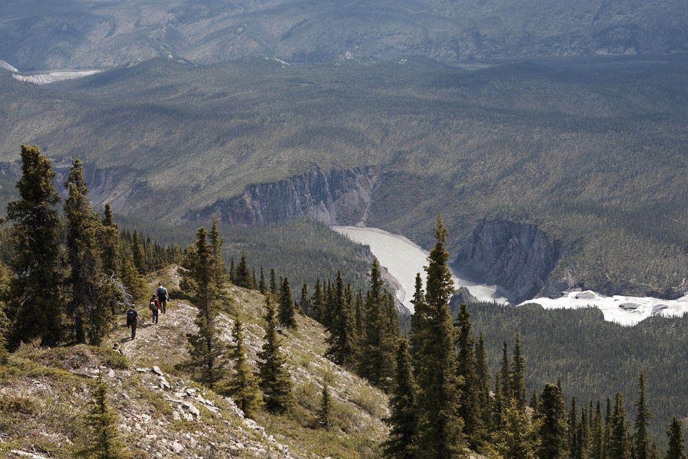 Hikers on their way back down from the peak of Sunblood Mountain, in Nahanni National Park Preserve, where they were awarded with an excellent view of the surrounding area.
