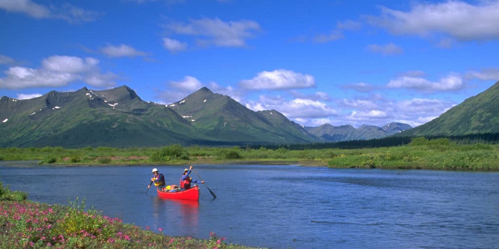 a group of people in a canoe on a river