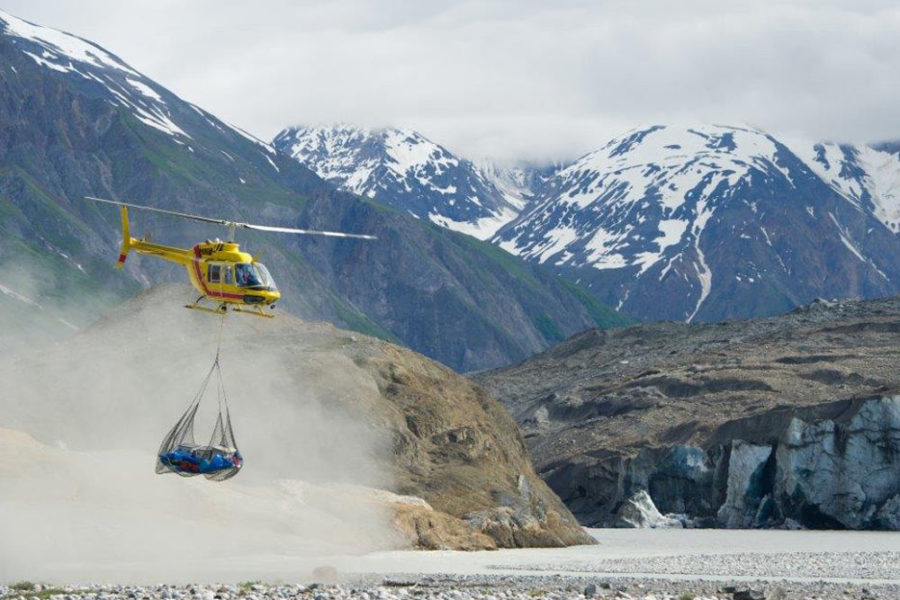 A helicopter portaging rafts over Turnback Canyon on our Alsek River Rafting Expedition.