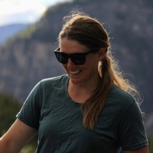 a woman wearing sunglasses and smiling