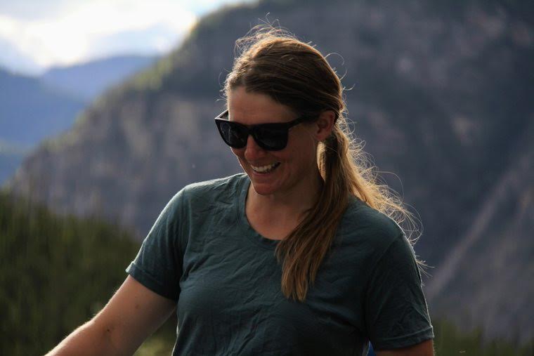 a woman wearing sunglasses and smiling