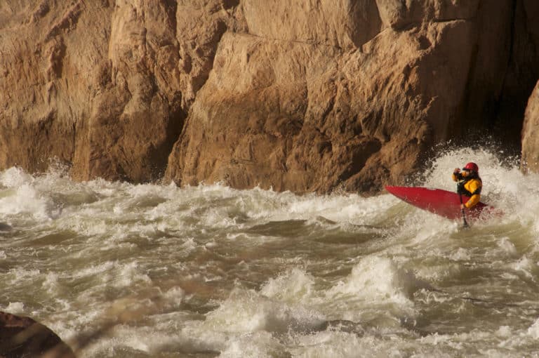 a person in a red kayak in the water