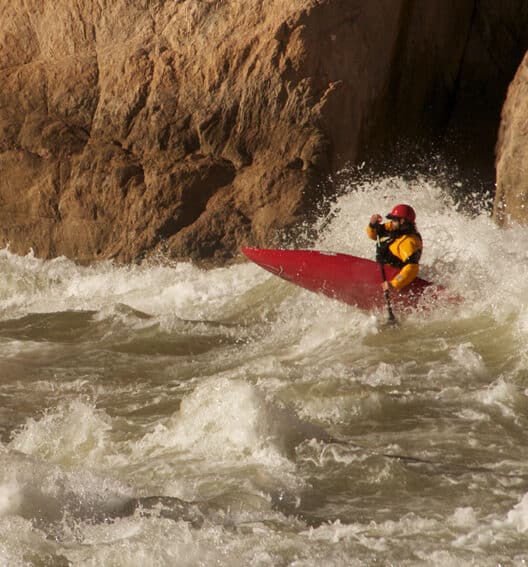 a person in a red kayak in the water
