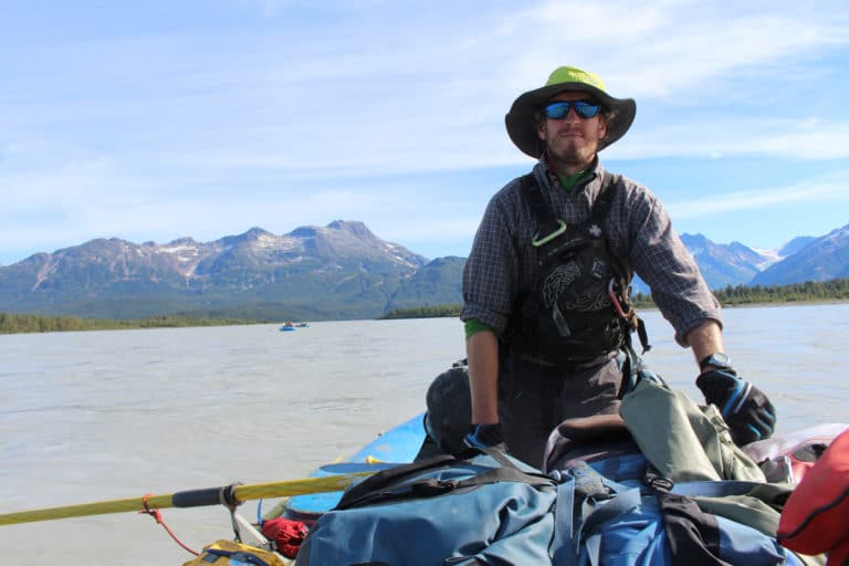 a man standing on a boat in the water