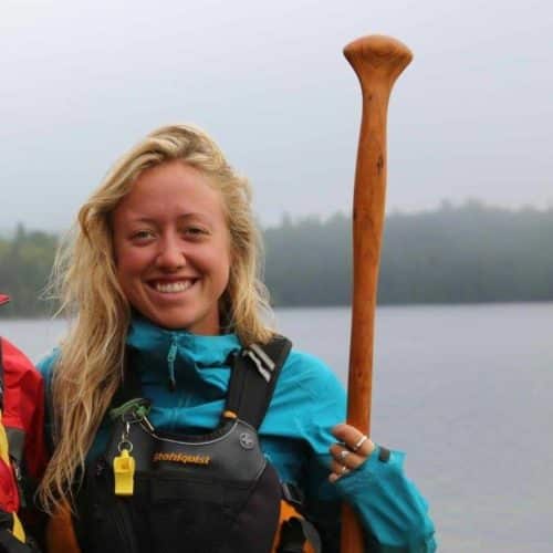 a woman holding a paddle