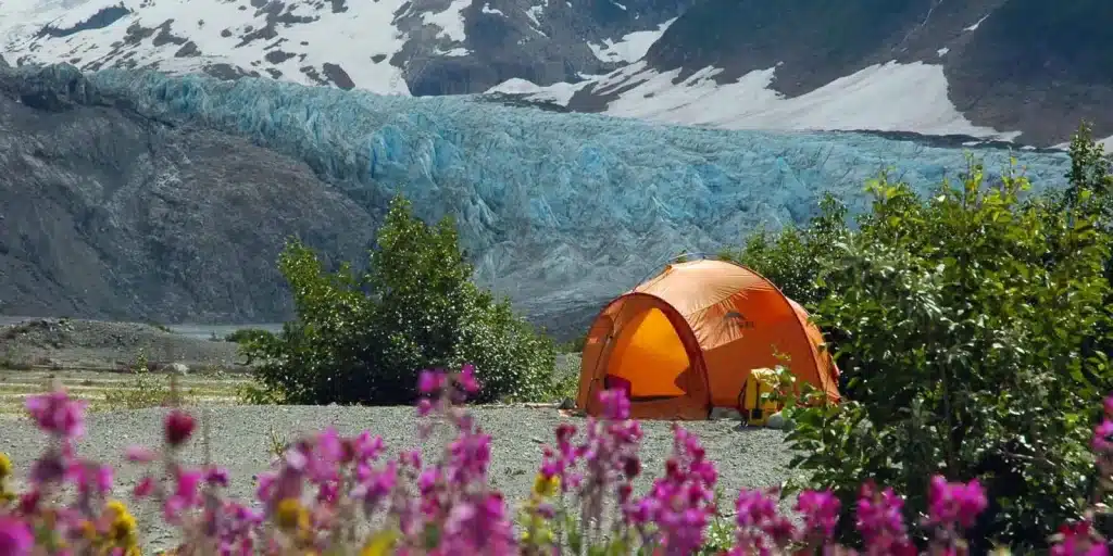 a tent in front of a glacier
