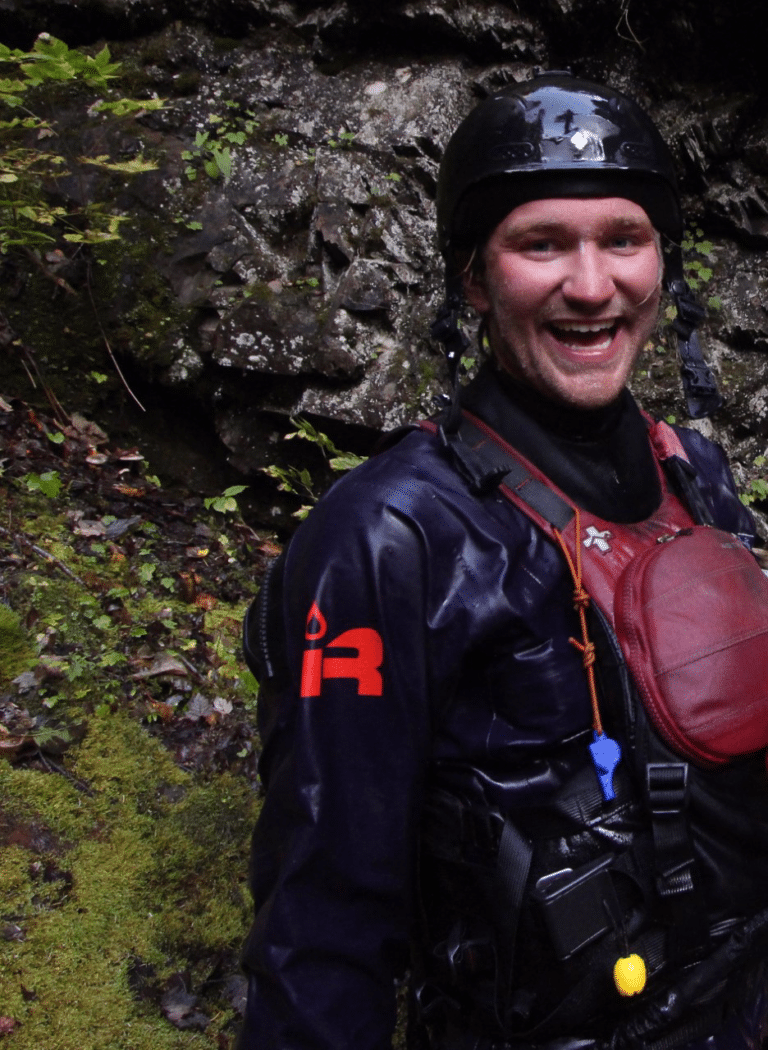 a man wearing a helmet and wet suit