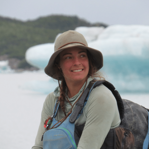 a woman wearing a hat and backpack