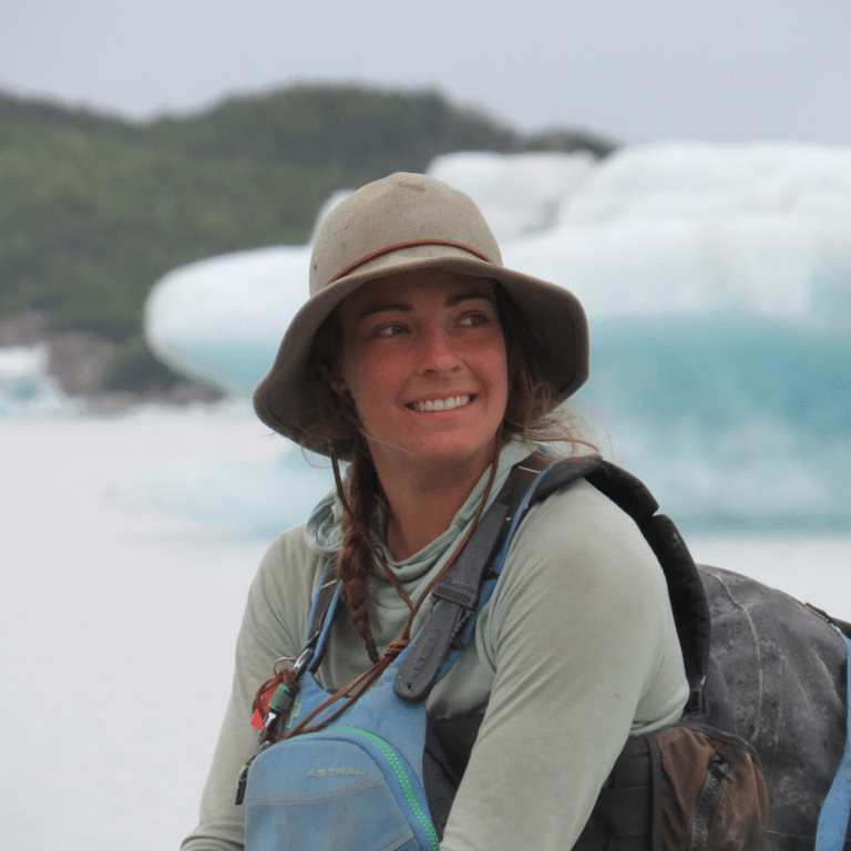 a woman wearing a hat and backpack