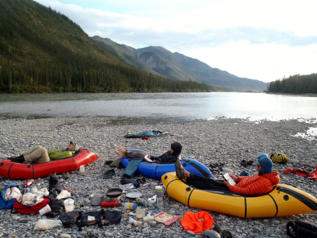Packrafters camping on the shores of the Nahanni River