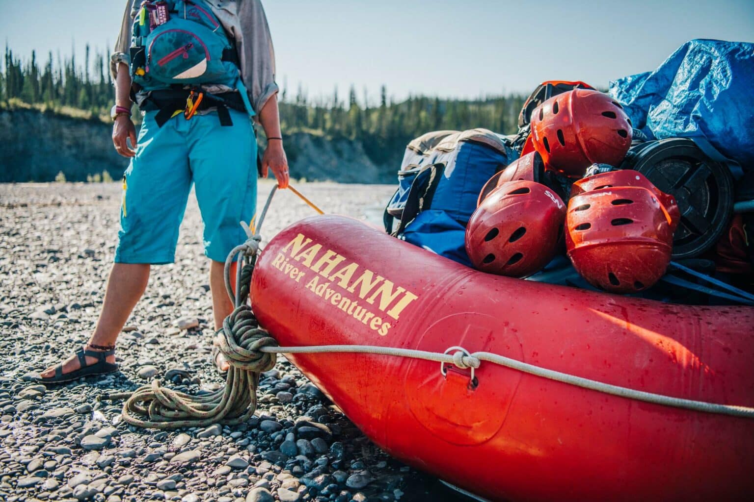 a person standing next to a raft