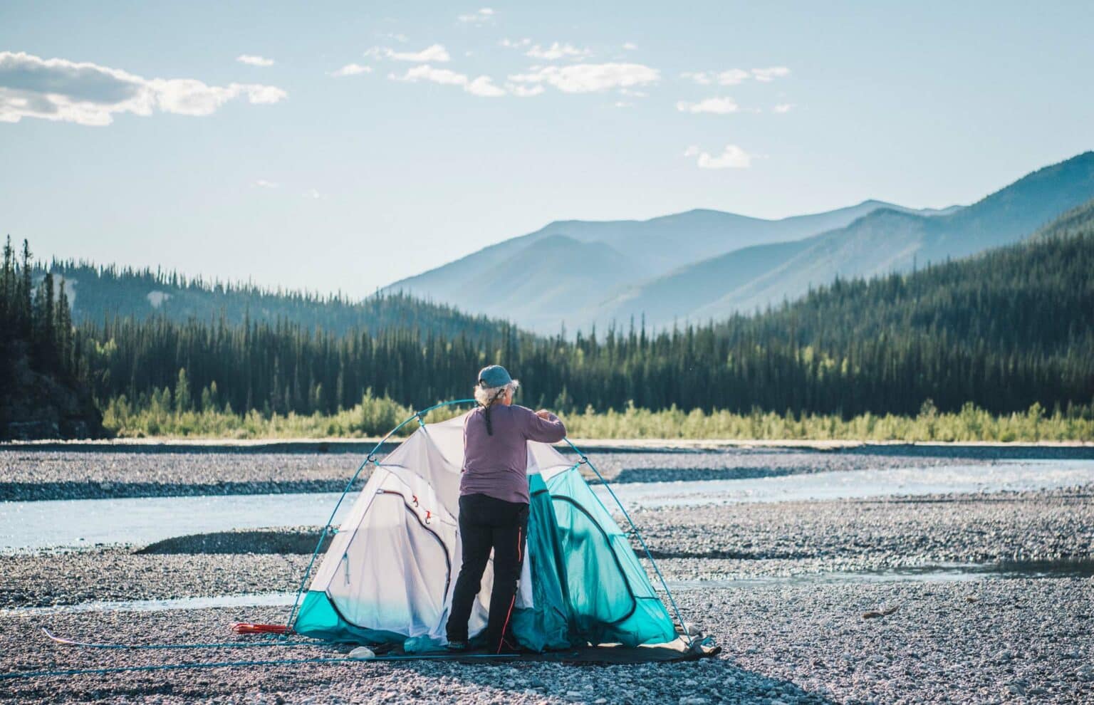 a woman standing next to a tent