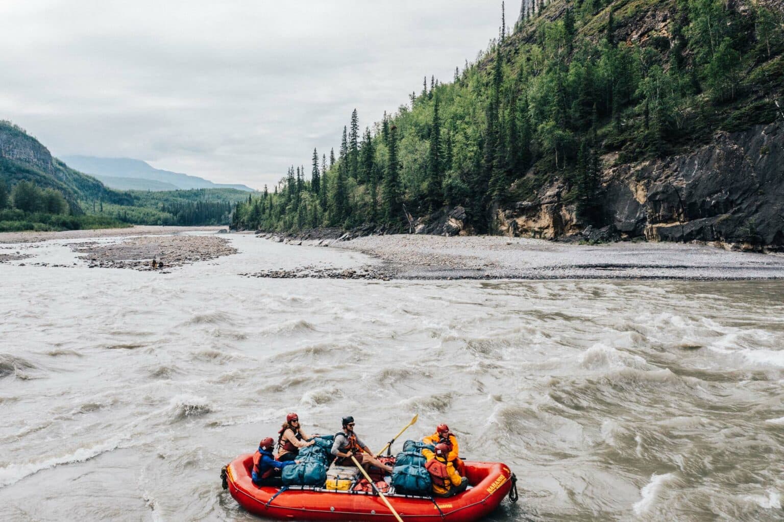 a group of people in a raft on a river