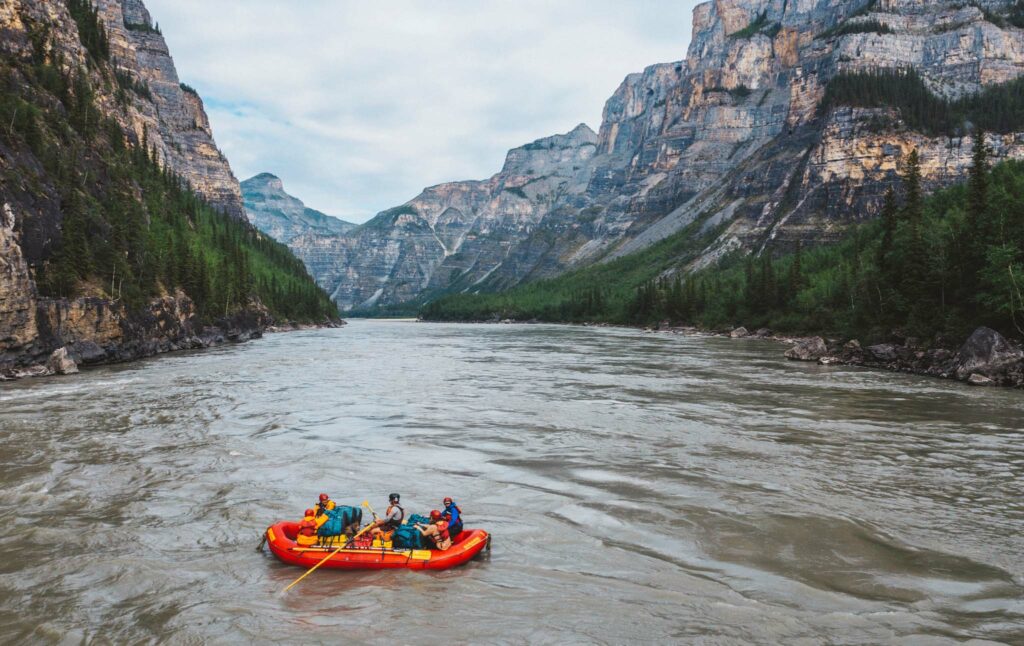 a group of people in a raft on a river