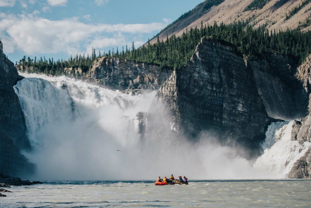 A raft on the Nahanni River in front of Virginia Falls.