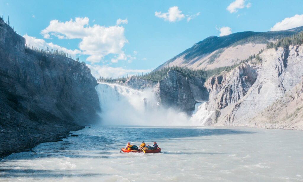 Rafters in front of Virginia Falls on the Nahanni River.