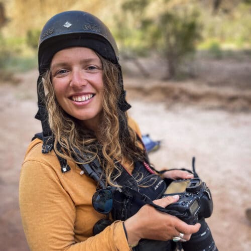 a woman wearing a helmet and holding a camera