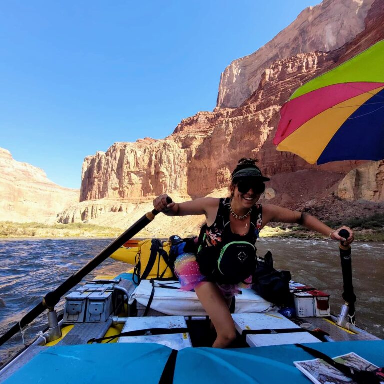 a woman on a boat with a parasail