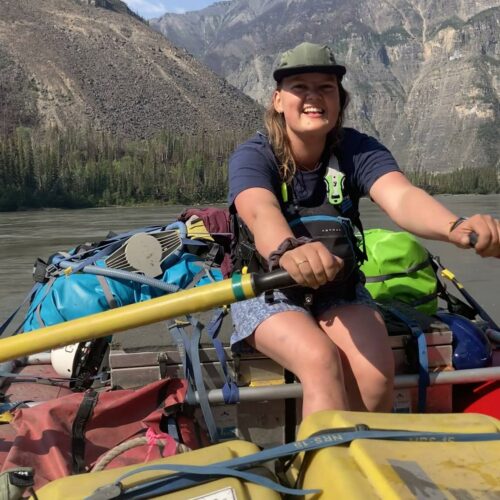 a woman on a boat with a paddle
