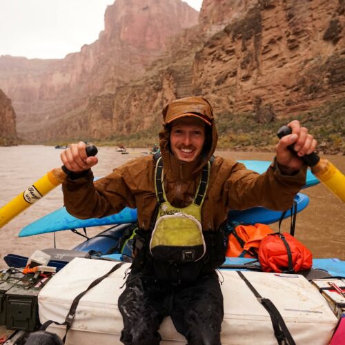 a man in a canoe with oars