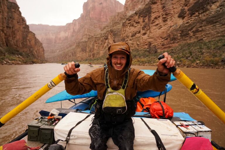 a man in a canoe with oars