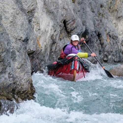 a person in a kayak in a river