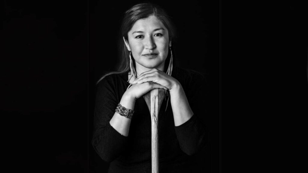 a woman holding a paddle