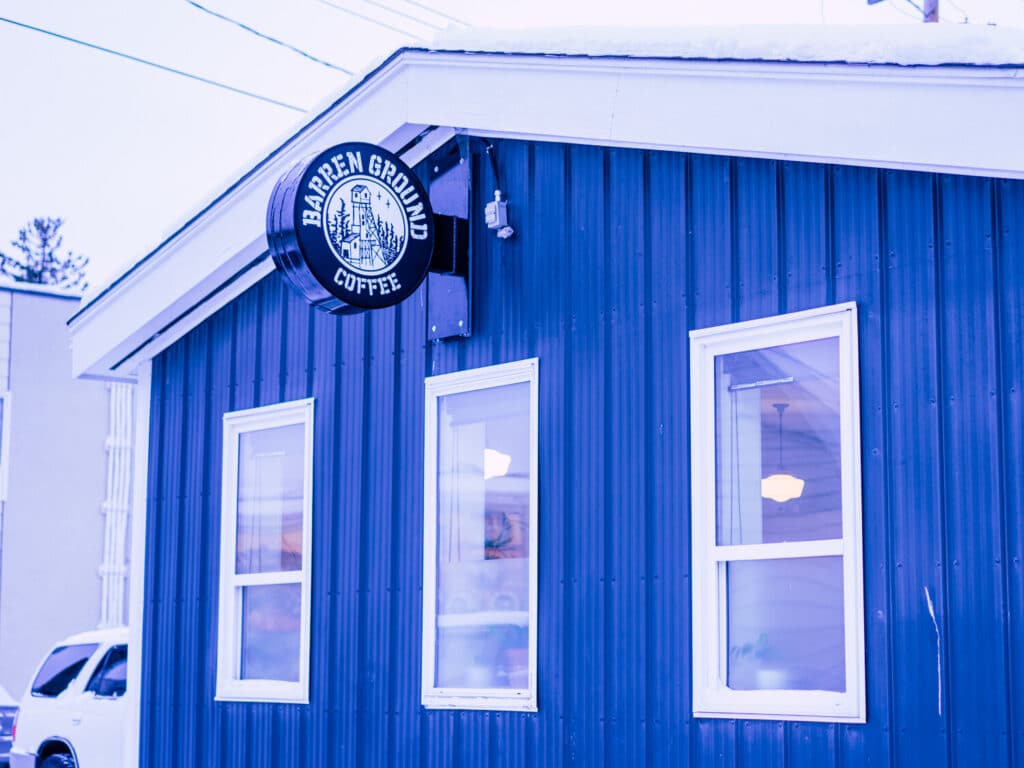 a blue building with a sign on the side