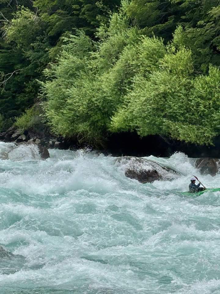 a person in a kayak in a river