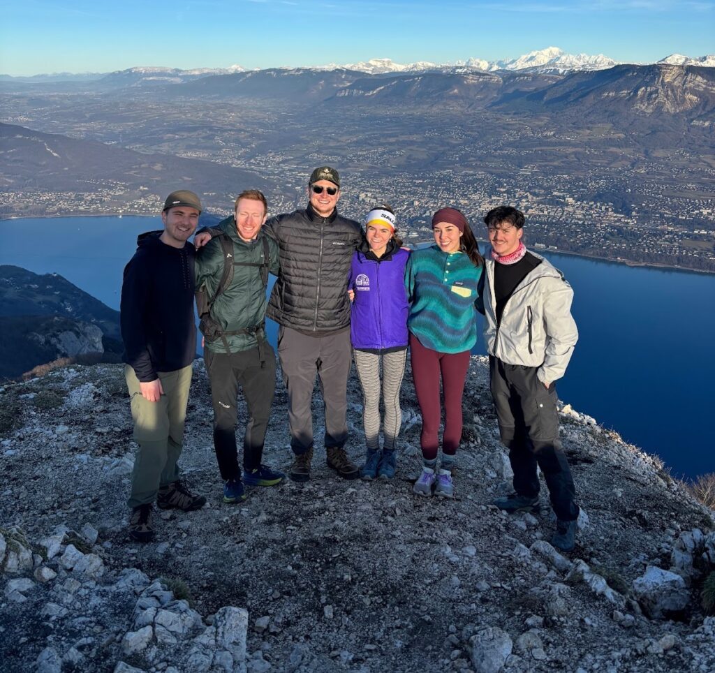 a group of people standing on a mountain top