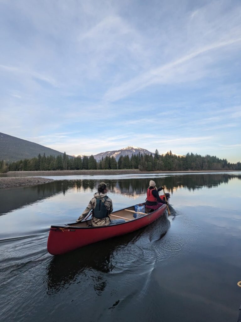 two people in a canoe on a lake