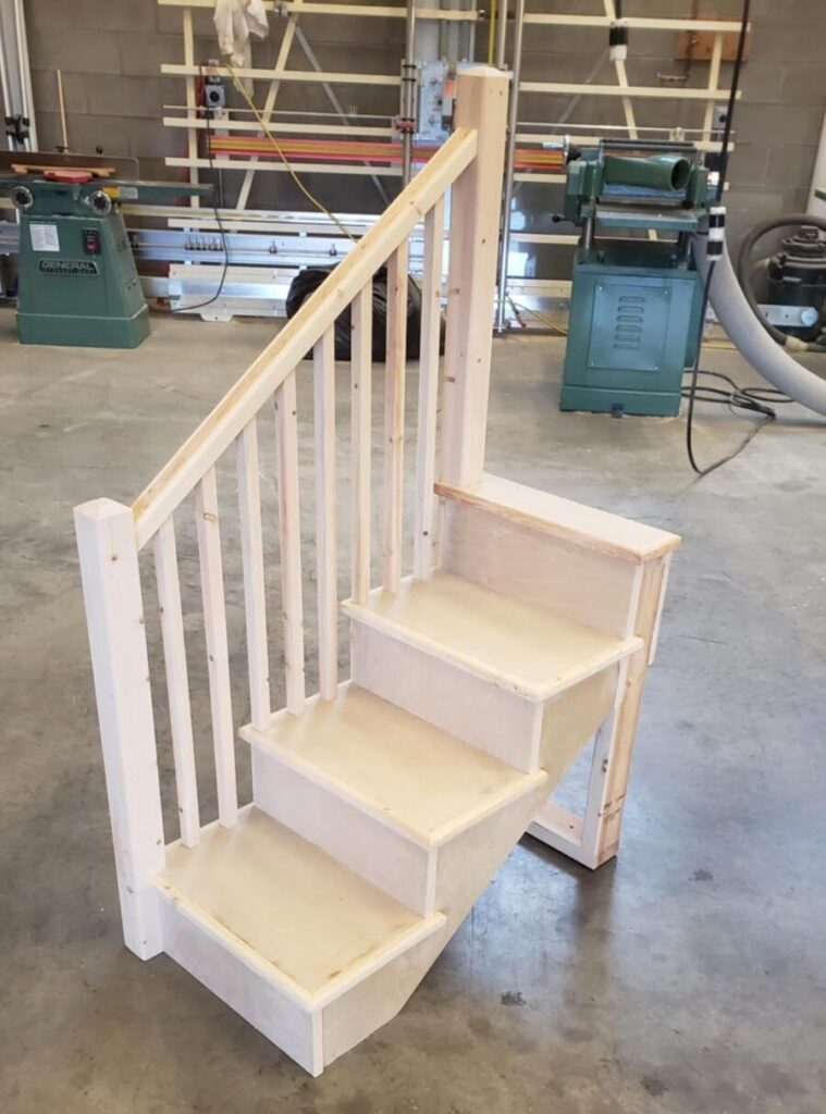 a wood staircase in a workshop