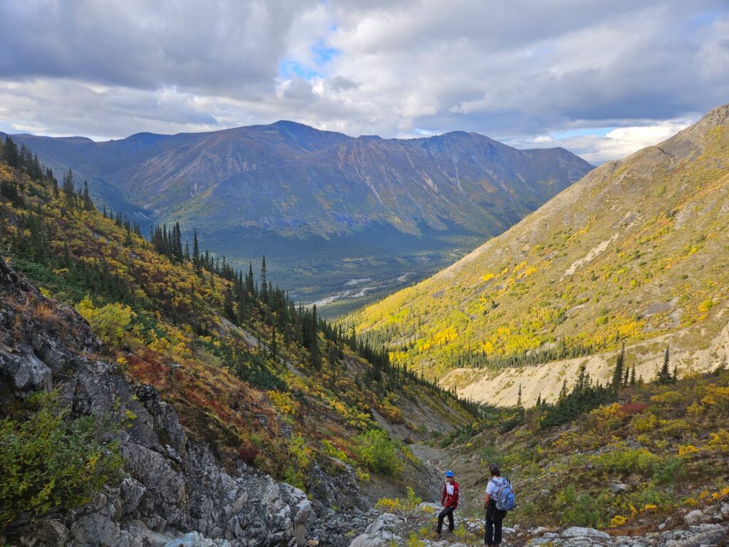 two people standing on a rocky mountain