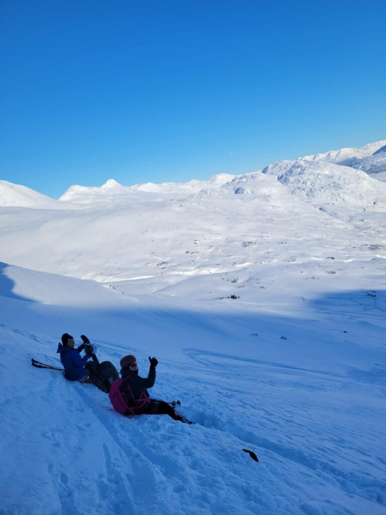 people sitting on the snow
