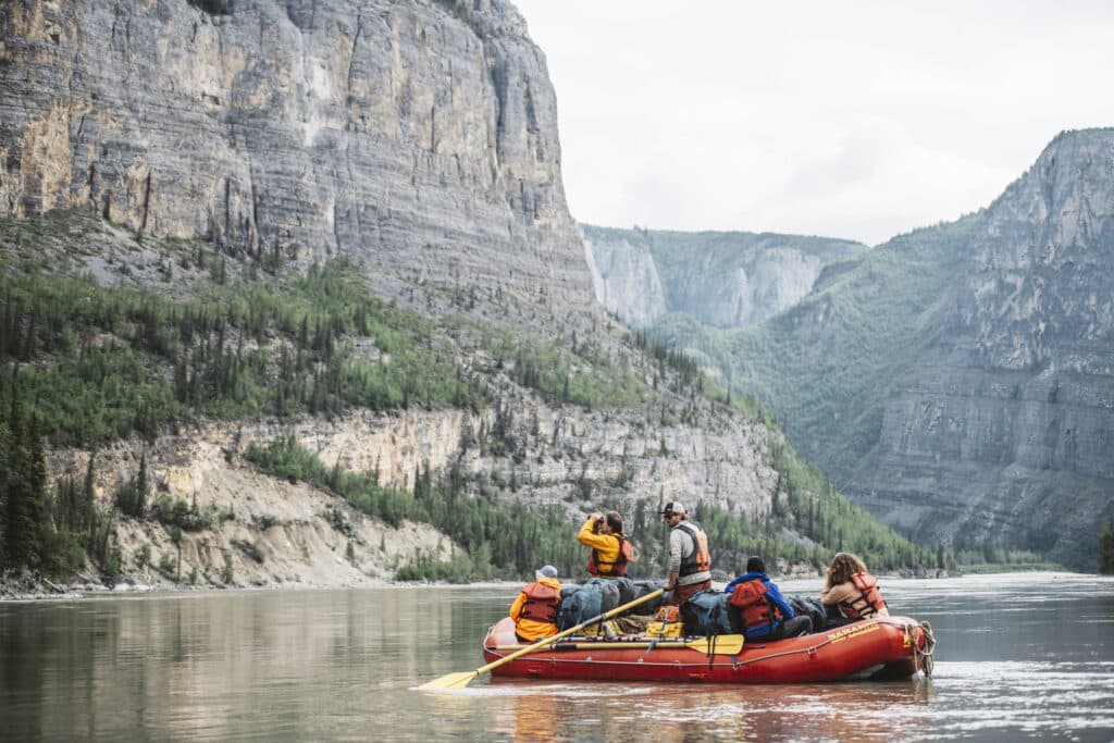 a group of people on a raft in a river
