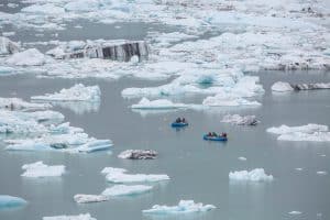 Kayakers among floating icebergs.