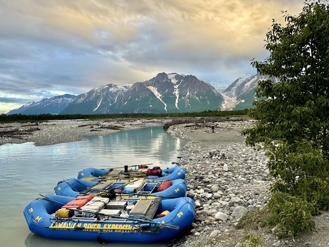 Rafts by a river and mountains