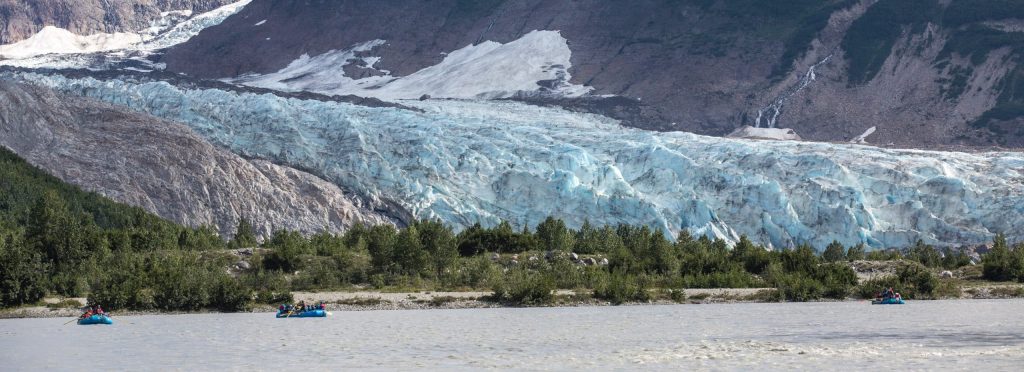 Glacier with kayakers in foreground